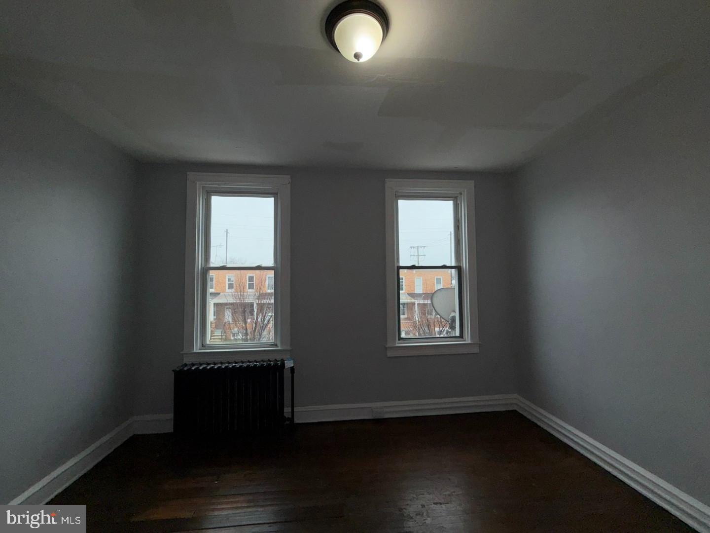 2606 Beryl Avenue Baltimore, MD 21205 - Photo 23 of 39 an empty room with wooden floor and windows