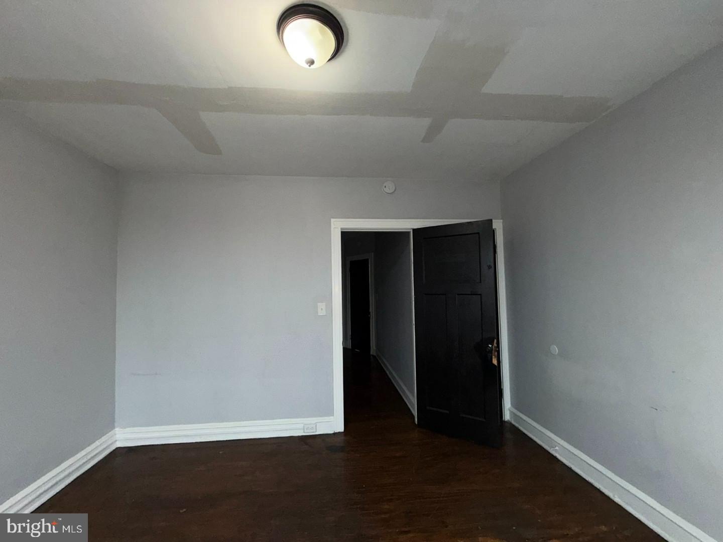 2606 Beryl Avenue Baltimore, MD 21205 - Photo 26 of 39 an empty room with wooden floor