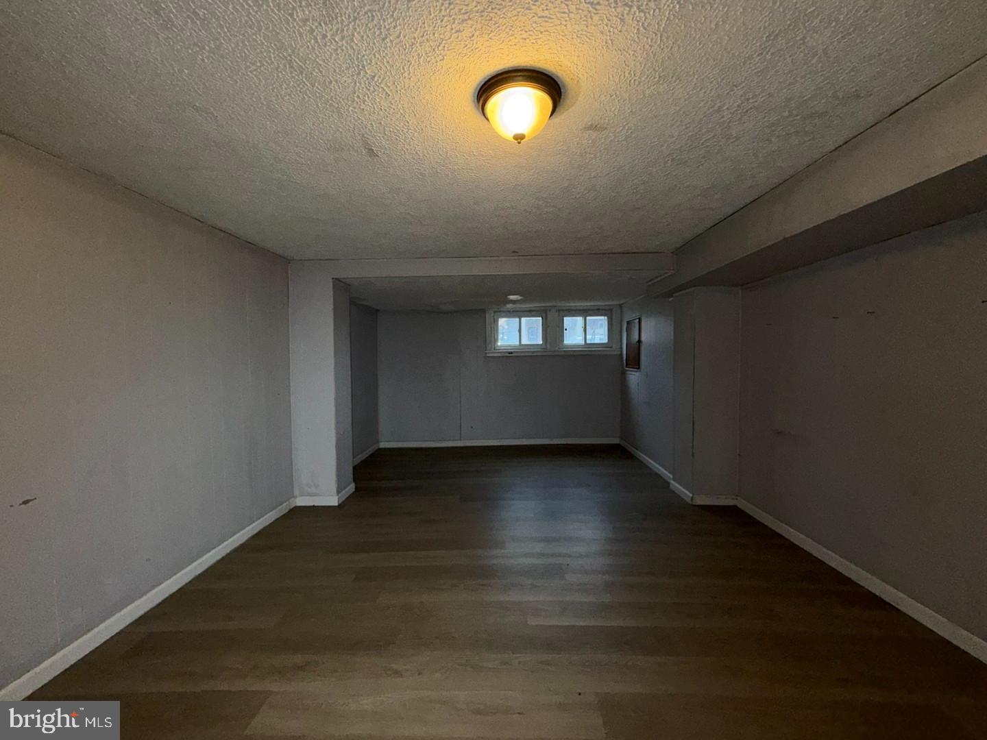 2606 Beryl Avenue Baltimore, MD 21205 - Photo 30 of 39 an empty room with wooden floor and windows