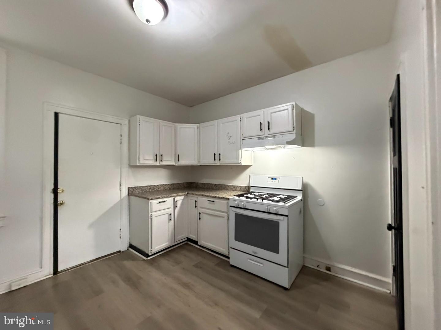 2606 Beryl Avenue Baltimore, MD 21205 - Photo 8 of 39 a kitchen with a stove top oven and cabinets
