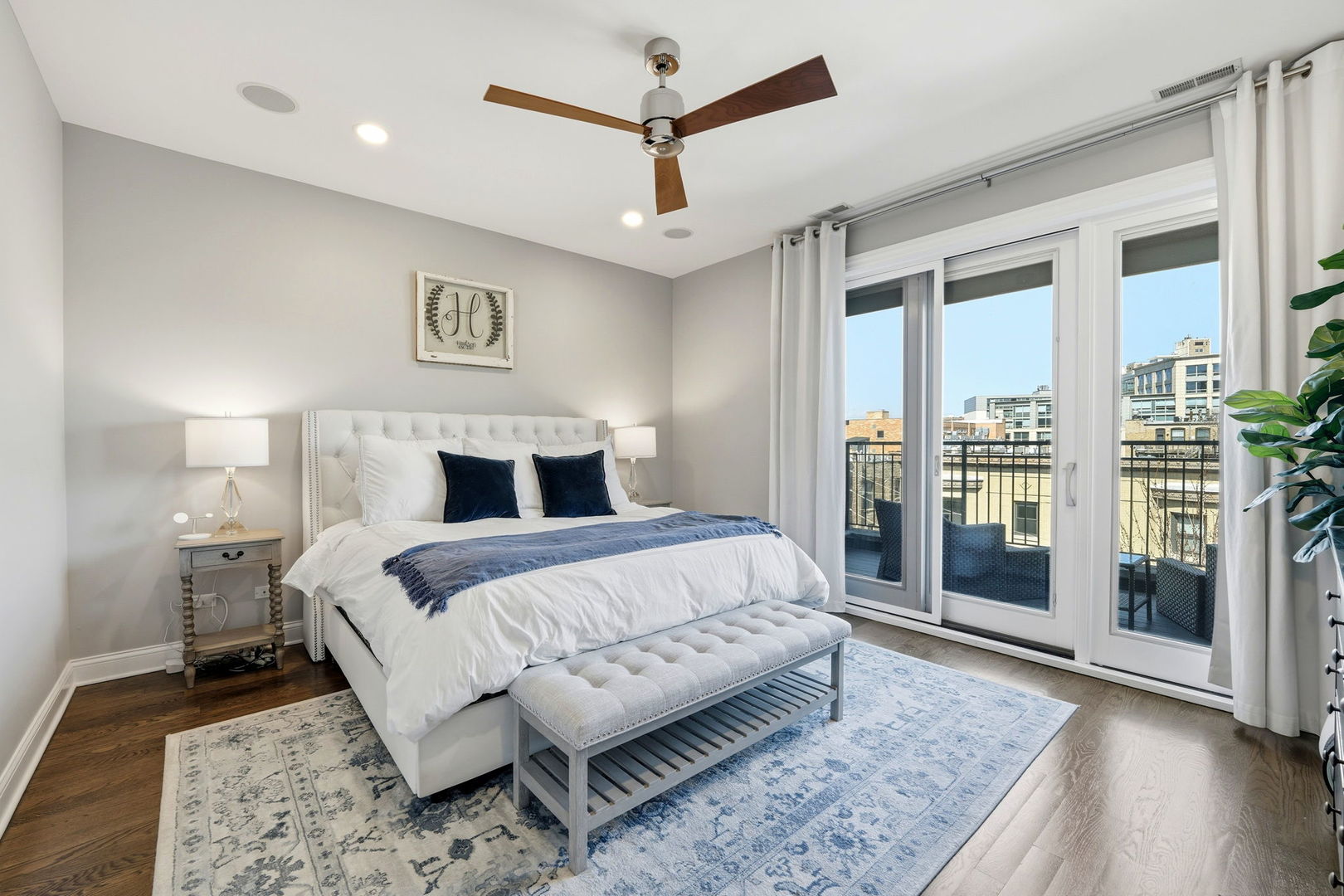 843 West Fletcher Street, Unit 3W Chicago, IL 60657 - Photo 18 of 45 a bedroom with a large bed and a chandelier