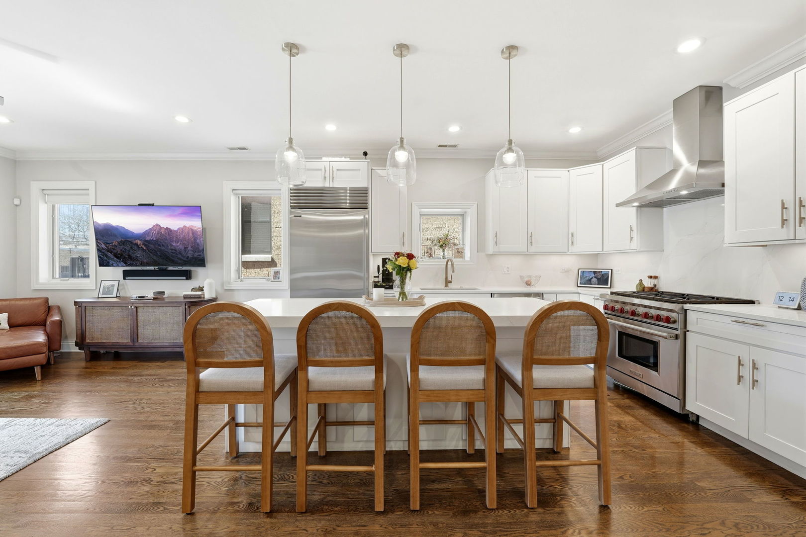 843 West Fletcher Street, Unit 3W Chicago, IL 60657 - Photo 8 of 45 a kitchen with stainless steel appliances kitchen island granite countertop a stove a sink a dining table and chairs with wooden floor