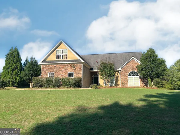 a front view of house with yard and green space