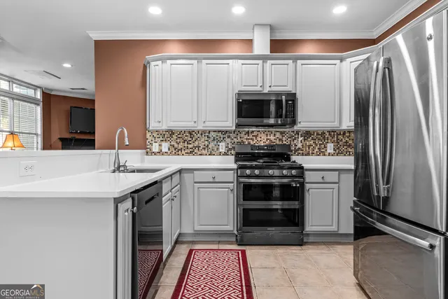 a kitchen with stainless steel appliances a stove sink and microwave