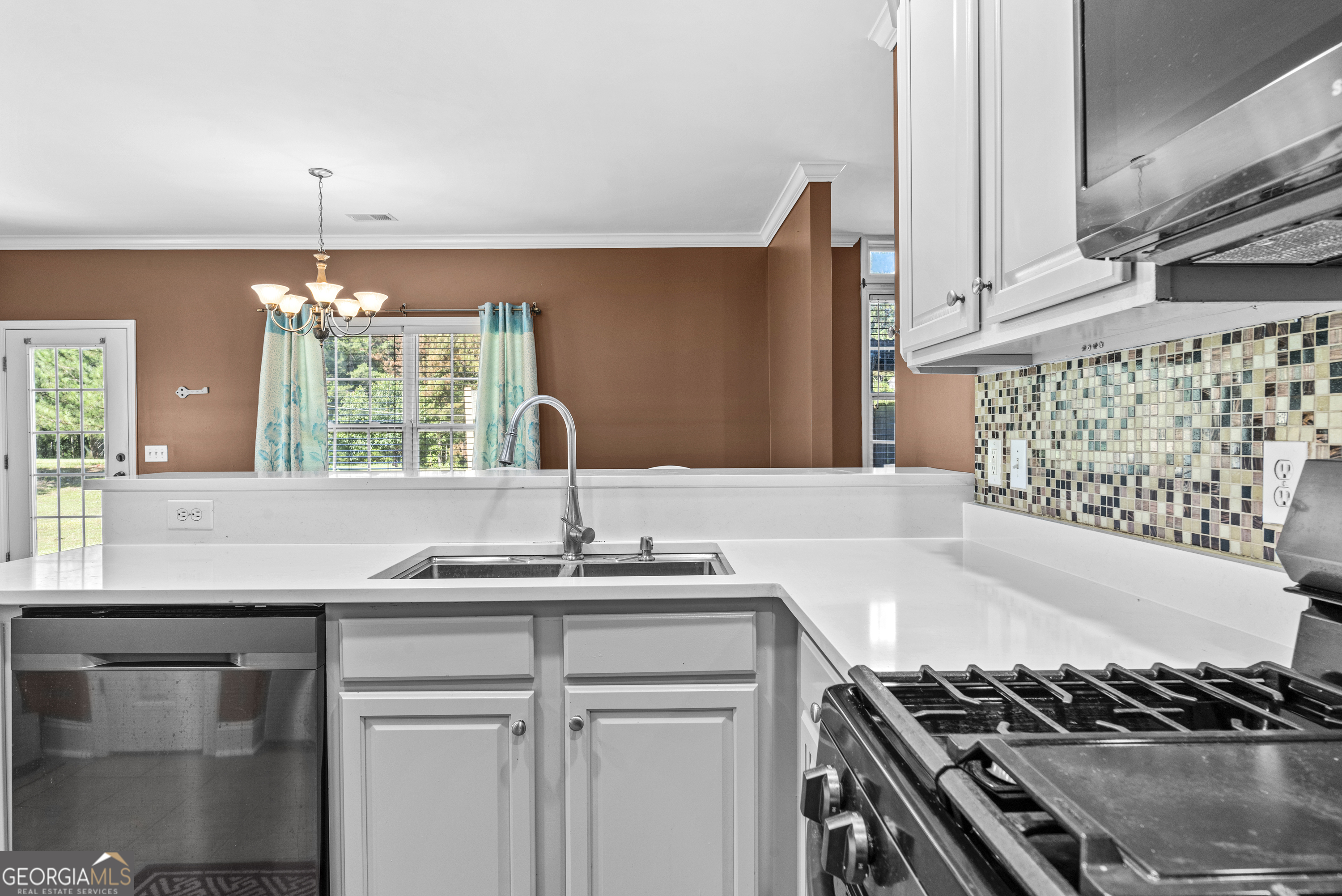 1141 Whispering Lakes Trail Madison, GA 30650 - Photo 14 of 40 a kitchen with a sink and a stove