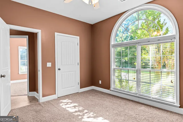 an empty room with a view of front door