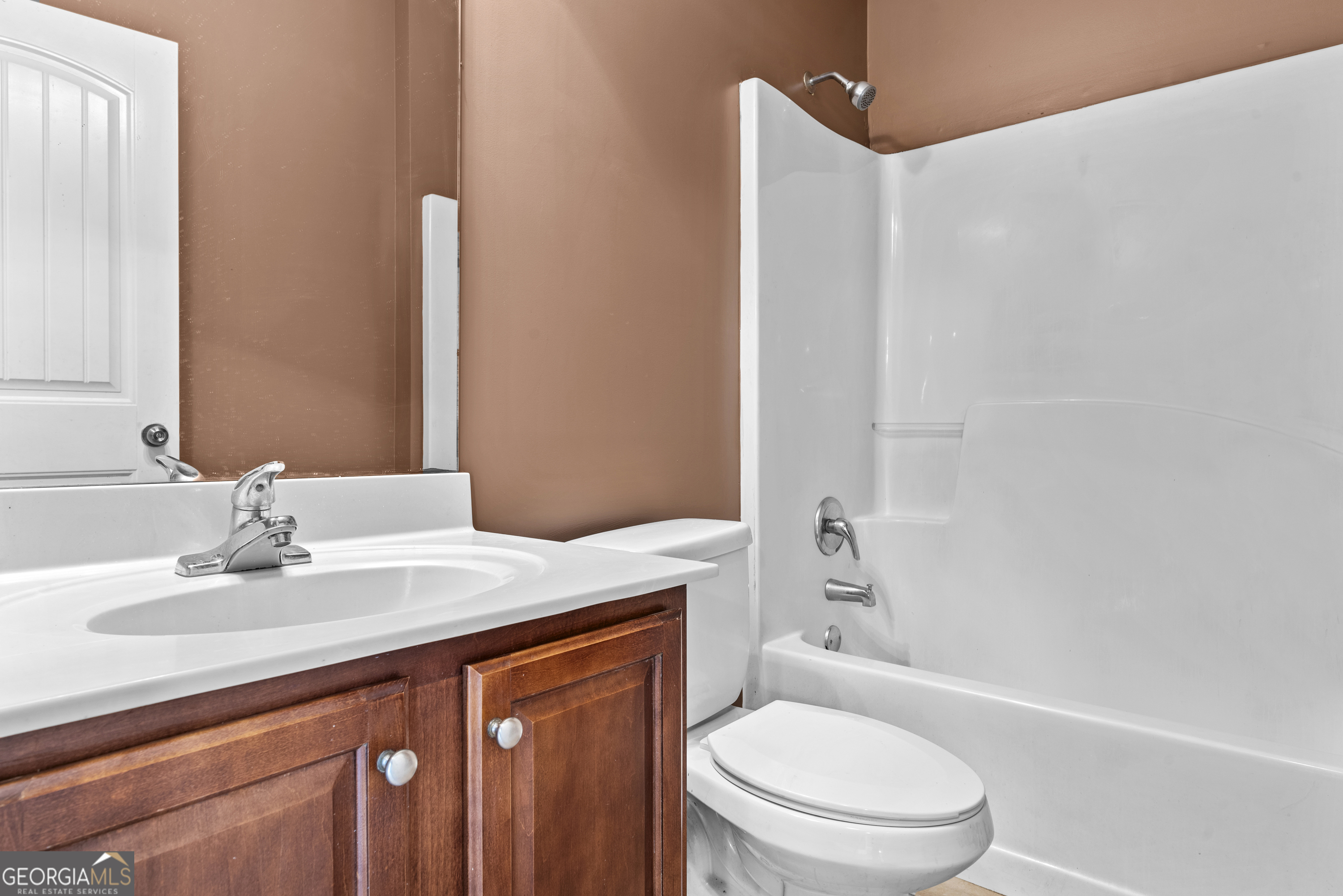 1141 Whispering Lakes Trail Madison, GA 30650 - Photo 22 of 40 a bathroom with a sink a toilet and shower