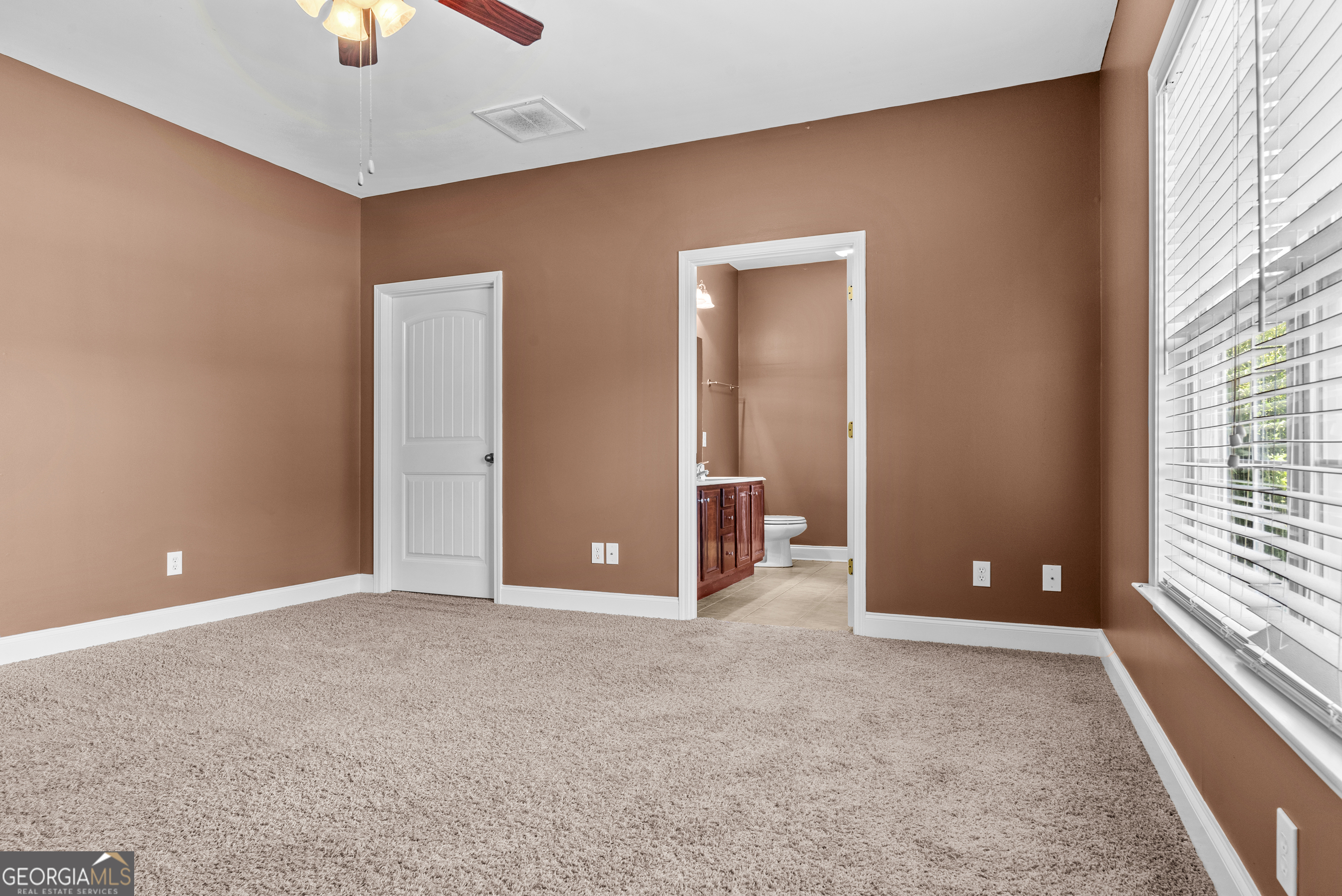 1141 Whispering Lakes Trail Madison, GA 30650 - Photo 24 of 40 wooden floor and windows in an empty room