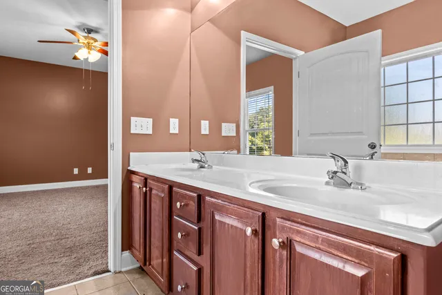 a bathroom with a double vanity sink and a mirror