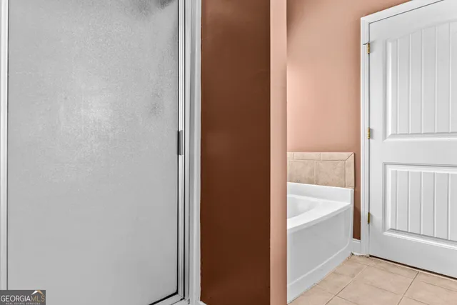 a view of bathroom with bathtub and shower