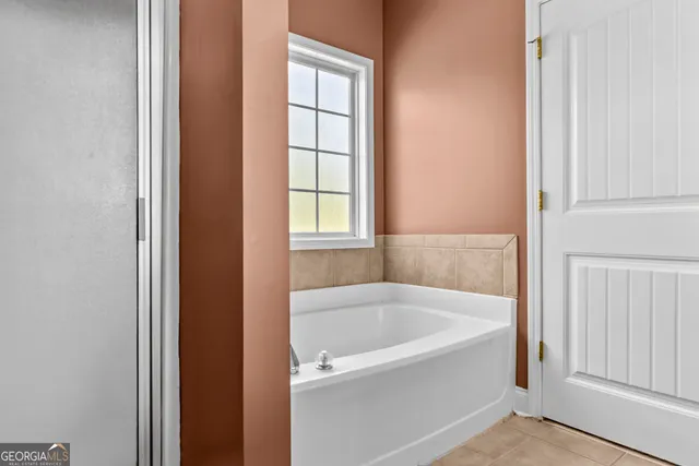 a white bath tub sitting next to a window