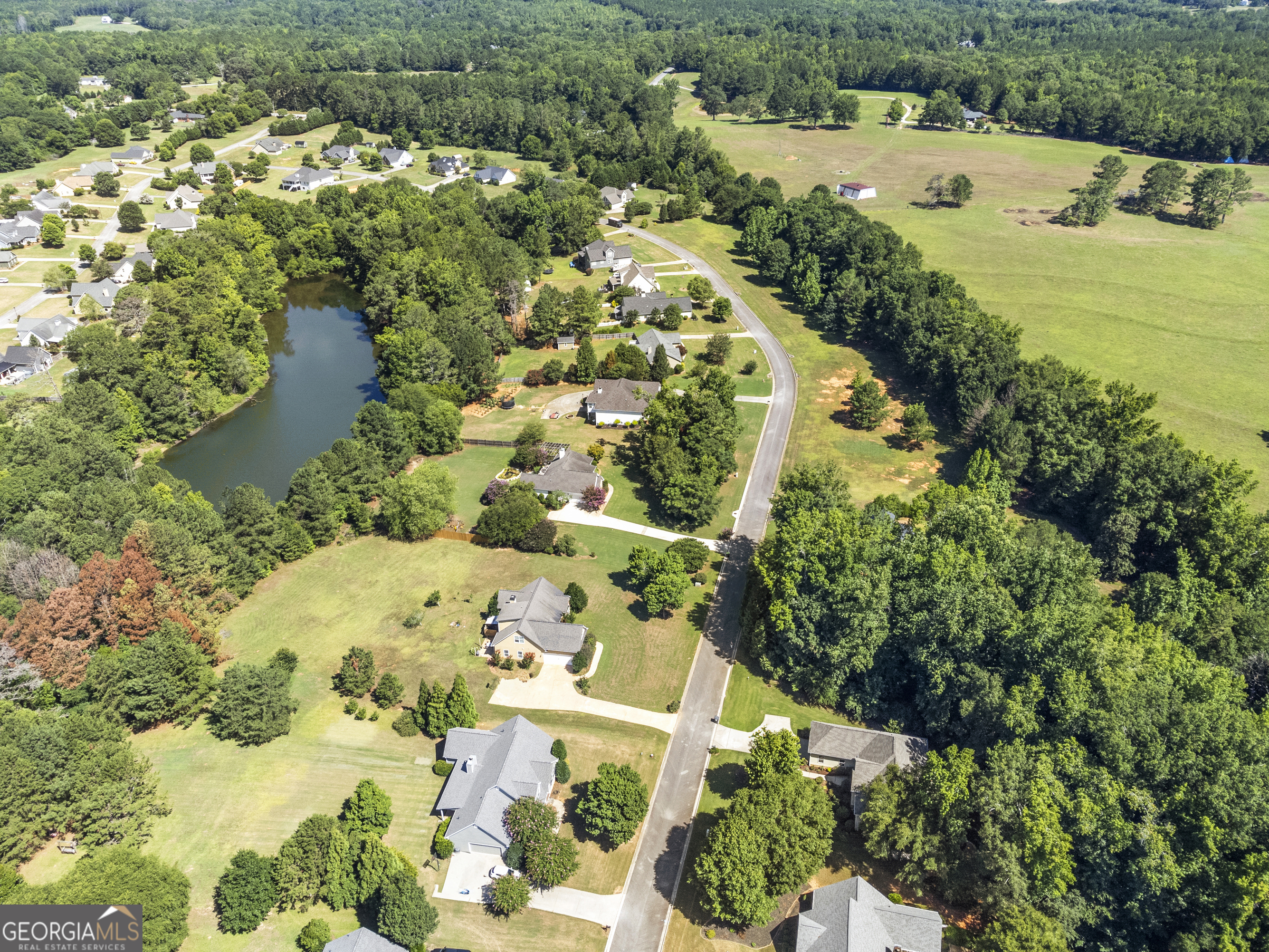 1141 Whispering Lakes Trail Madison, GA 30650 - Photo 3 of 40 a view of a lake with a yard