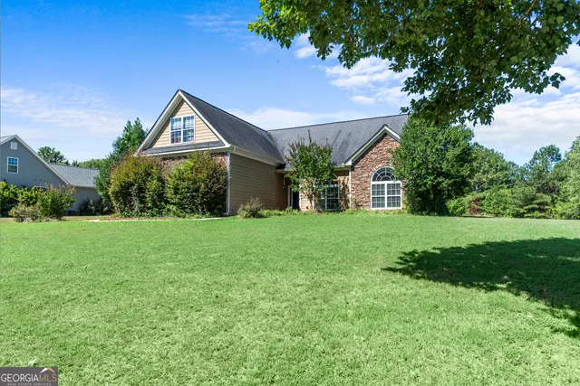 a front view of a house with garden