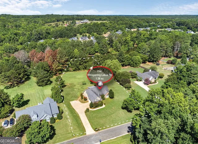 an aerial view of a house with a yard