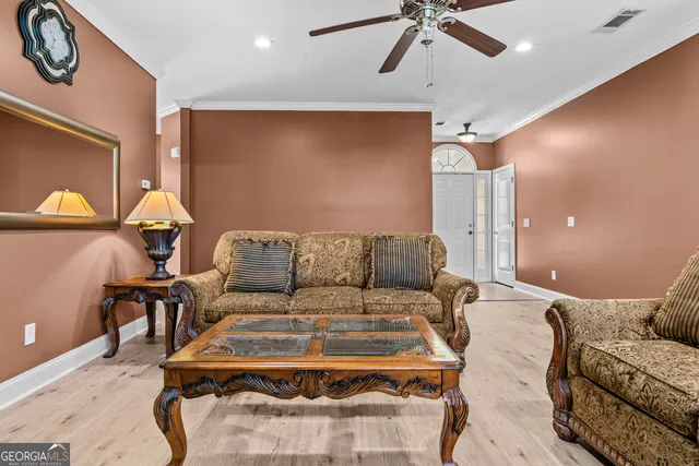 a living room with furniture and a chandelier