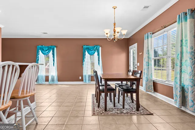 a view of a dining room with furniture and window