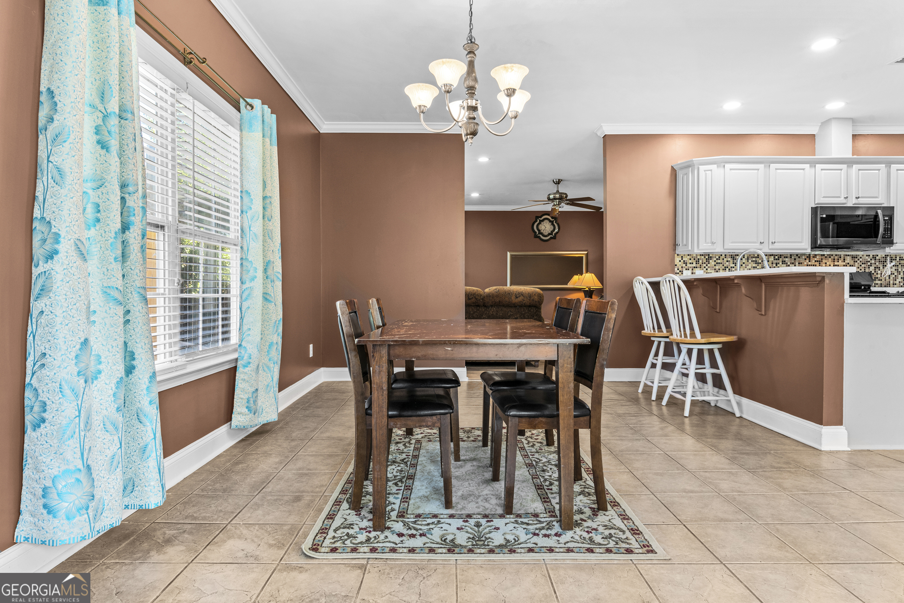 1141 Whispering Lakes Trail Madison, GA 30650 - Photo 10 of 40 a view of a dining room with furniture window and wooden floor