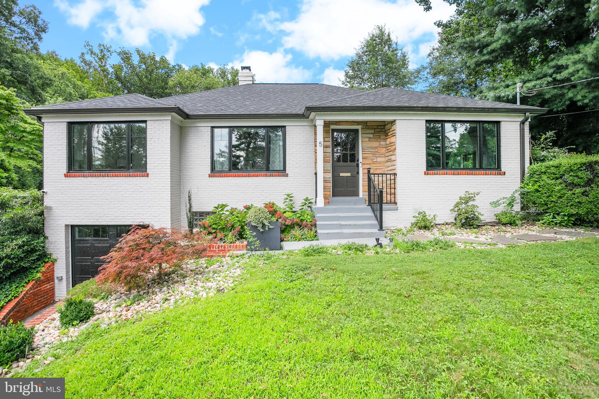 a front view of a house with a yard and porch