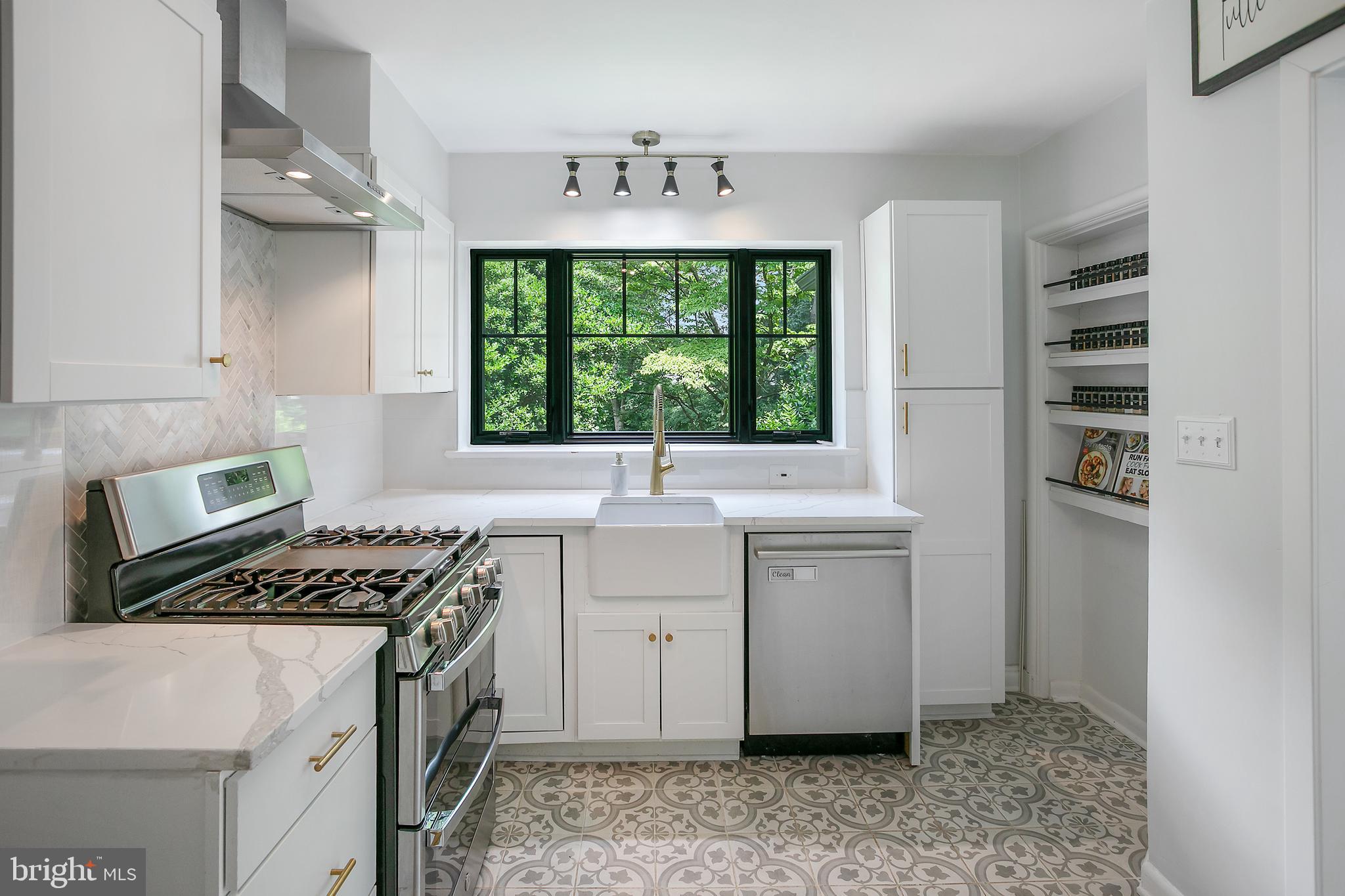 5 Spring Hill Court Chevy Chase, MD 20815 - Photo 13 of 50 a kitchen with a stove a sink and a window