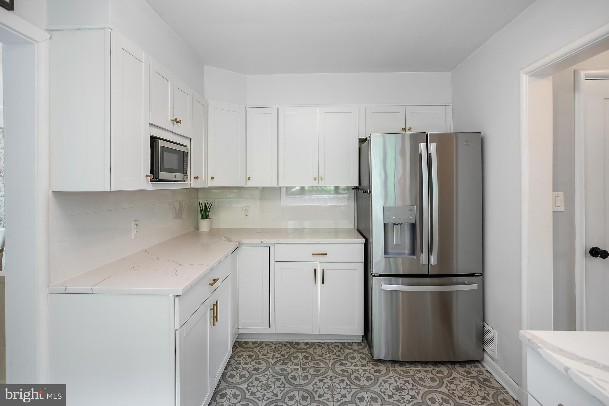 5 Spring Hill Court Chevy Chase, MD 20815 - Photo 15 of 50 a kitchen with a refrigerator sink and cabinets