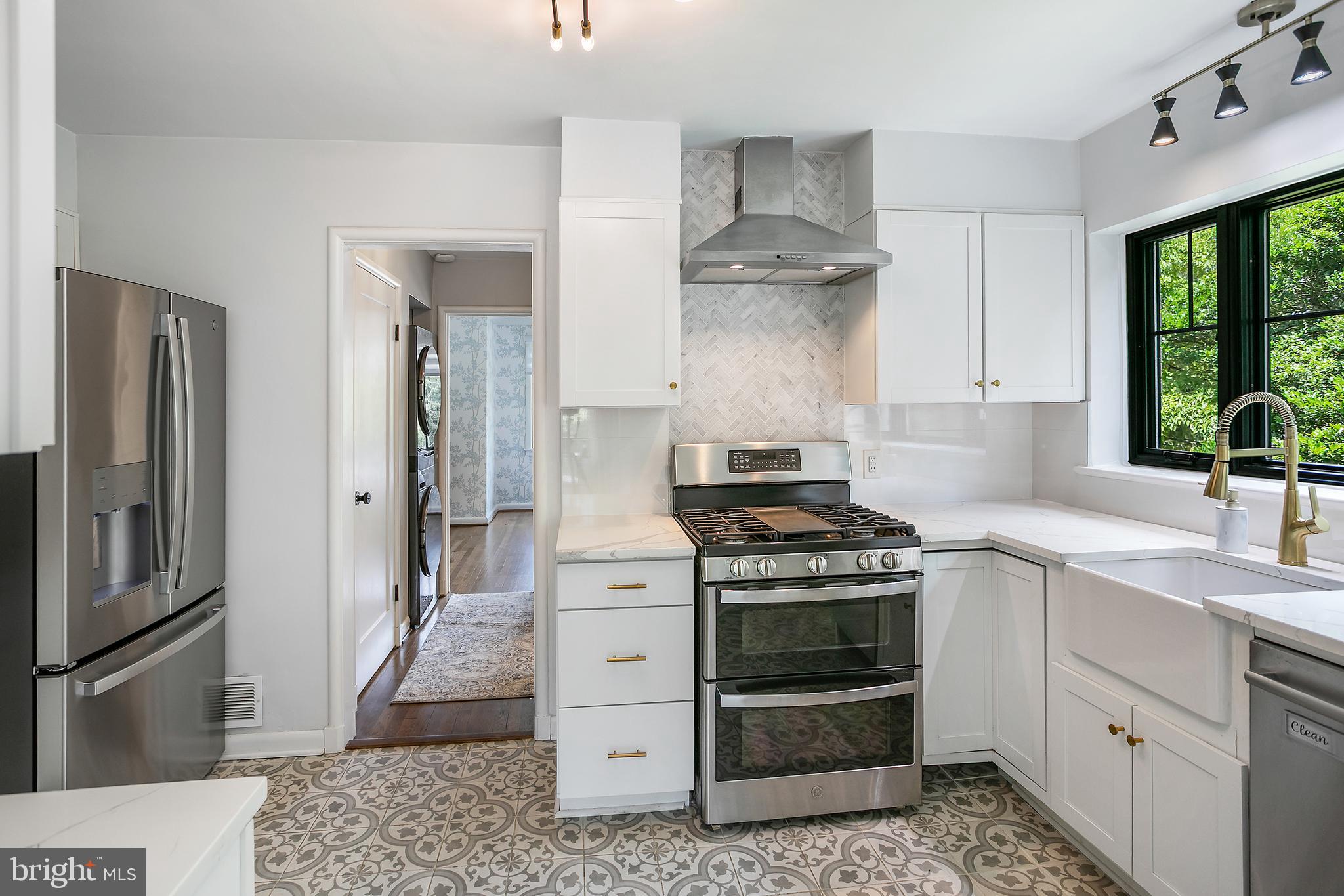 5 Spring Hill Court Chevy Chase, MD 20815 - Photo 16 of 50 a kitchen with stainless steel appliances a stove and a refrigerator