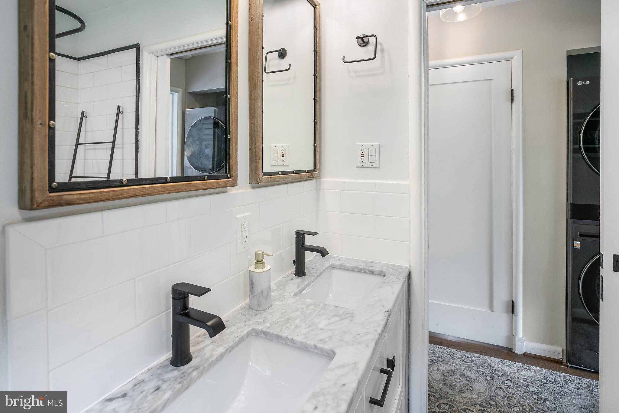 5 Spring Hill Court Chevy Chase, MD 20815 - Photo 19 of 50 a bathroom with a granite countertop sink a mirror and shower