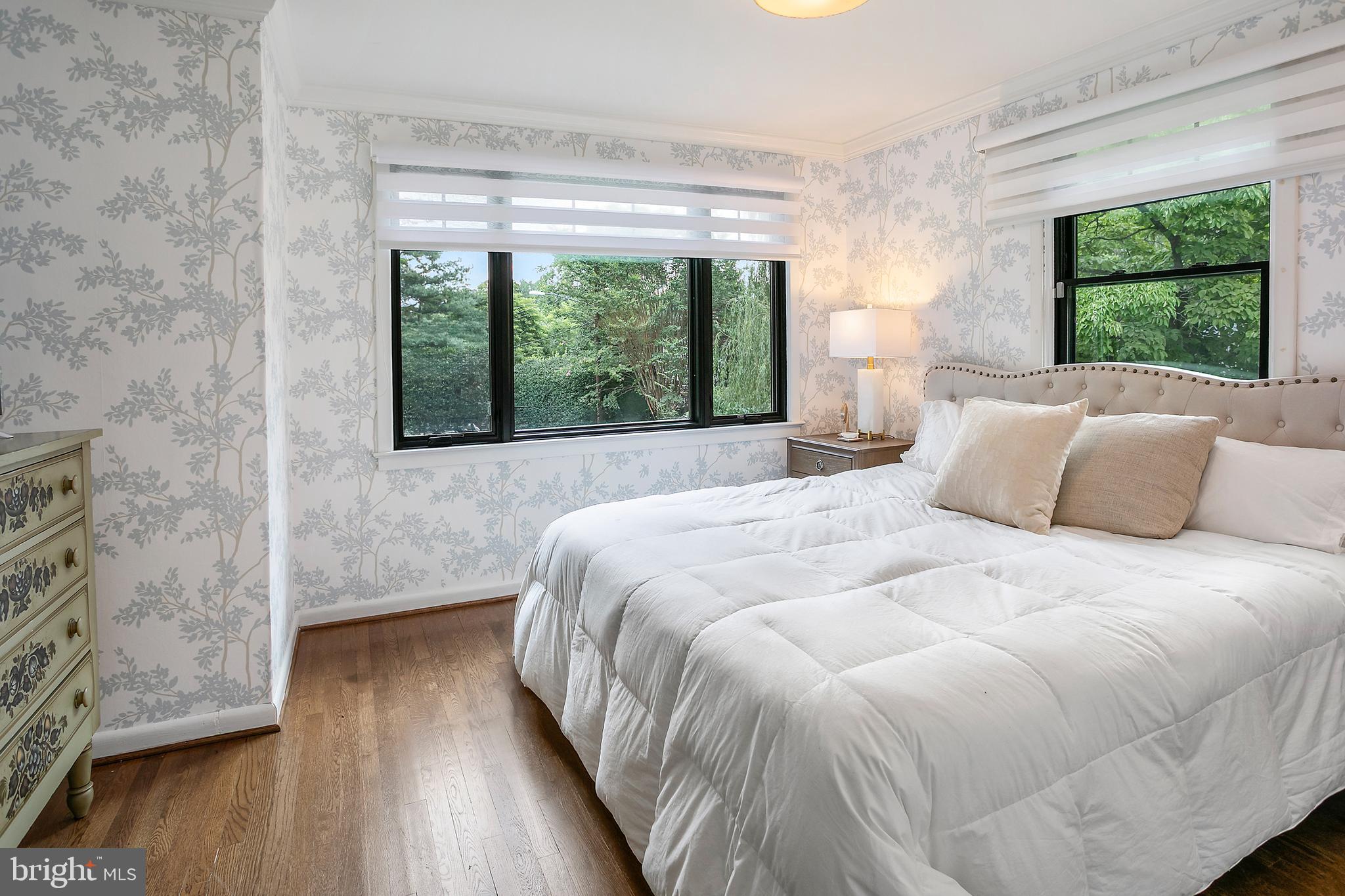 5 Spring Hill Court Chevy Chase, MD 20815 - Photo 20 of 50 a large bed sitting in a bedroom next to a window