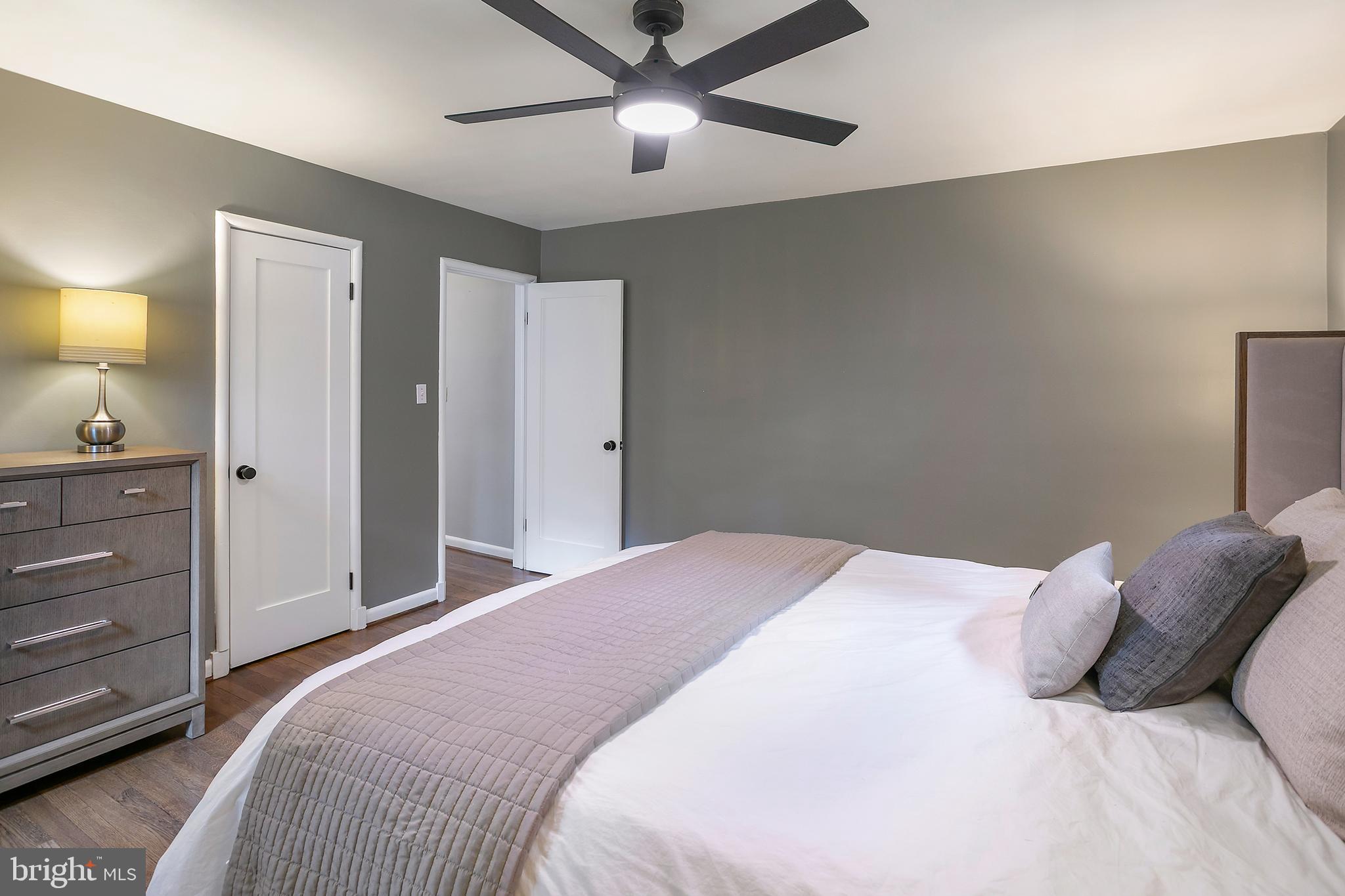 5 Spring Hill Court Chevy Chase, MD 20815 - Photo 26 of 50 a bedroom with a bed and a lamp