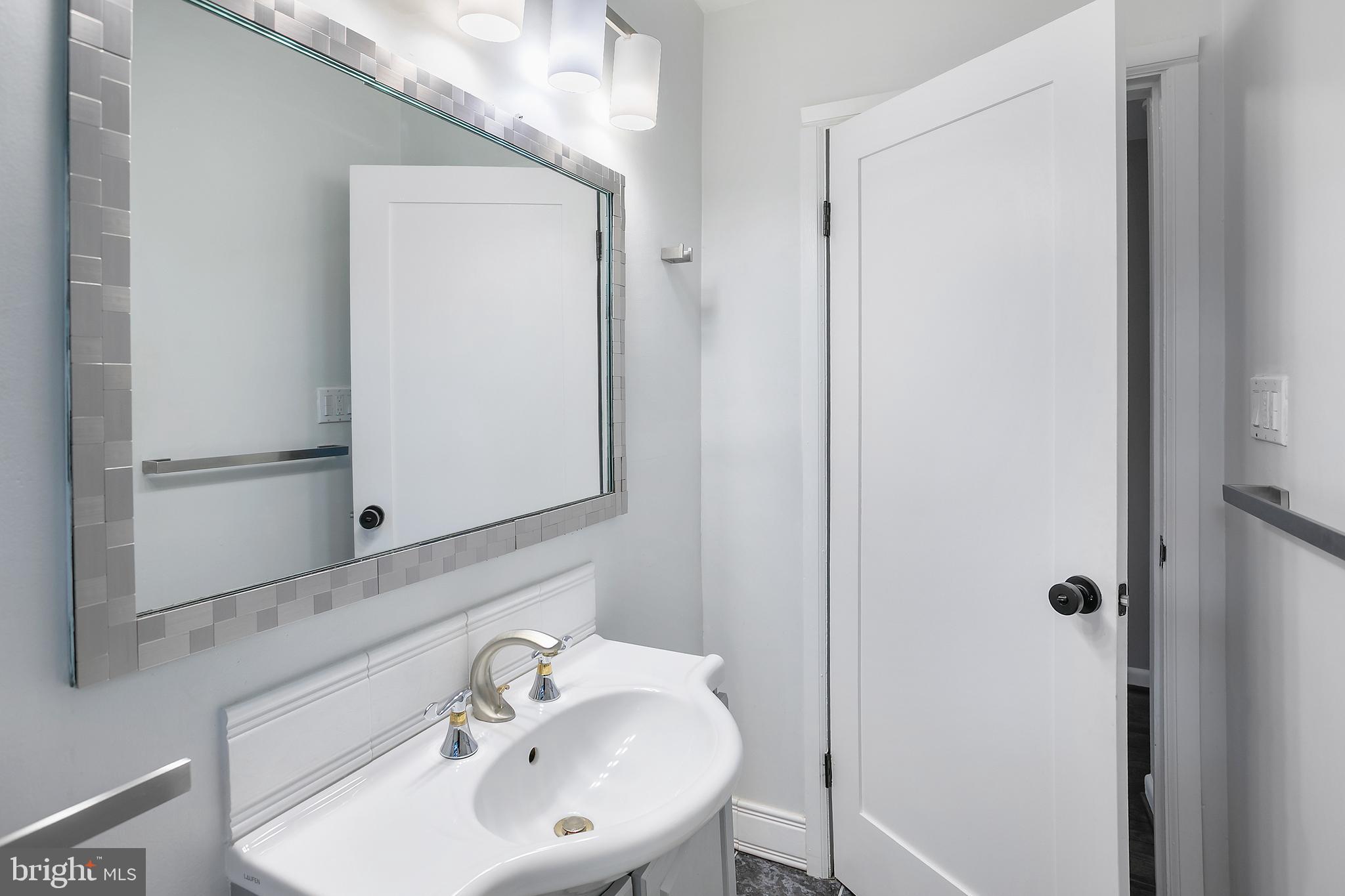 5 Spring Hill Court Chevy Chase, MD 20815 - Photo 28 of 50 a bathroom with a sink and a mirror