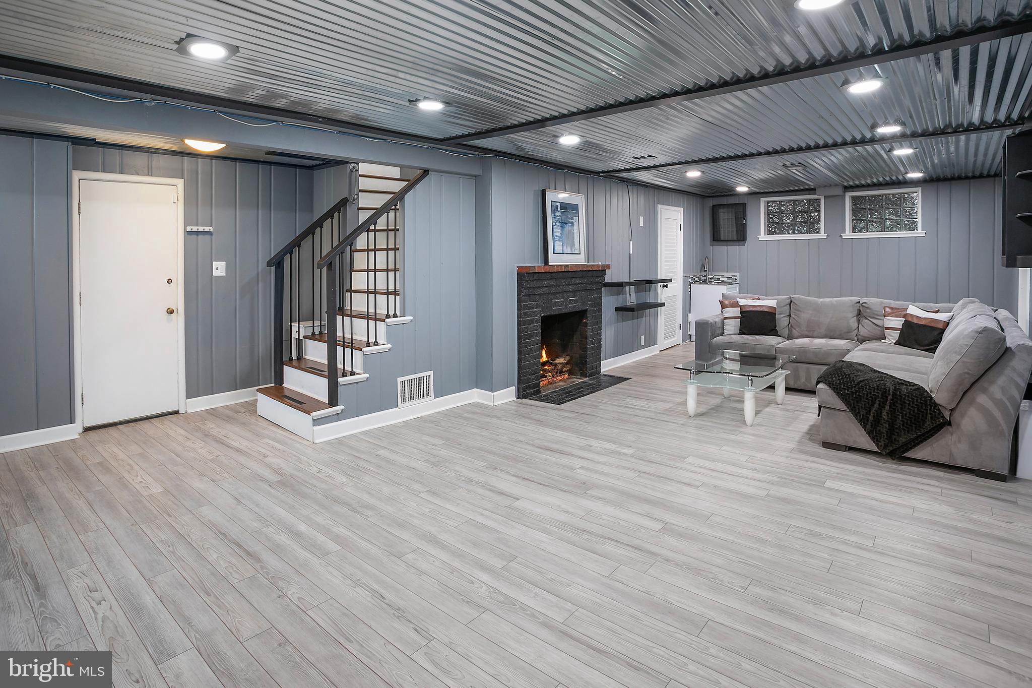 5 Spring Hill Court Chevy Chase, MD 20815 - Photo 31 of 50 a living room with furniture wooden floor and a fireplace