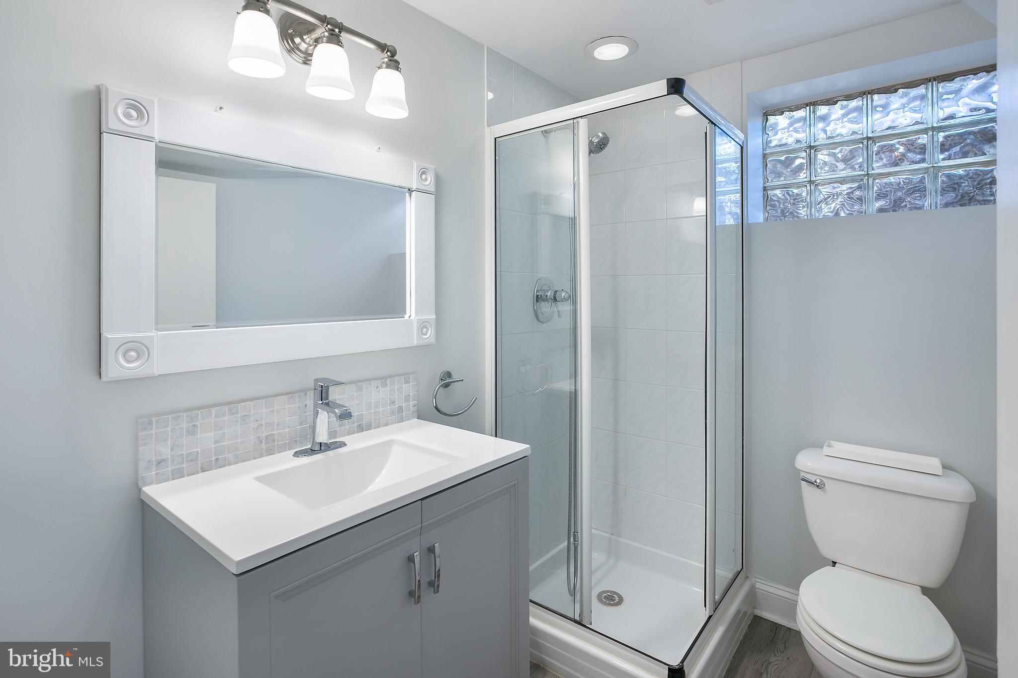 5 Spring Hill Court Chevy Chase, MD 20815 - Photo 35 of 50 a bathroom with a sink toilet and shower