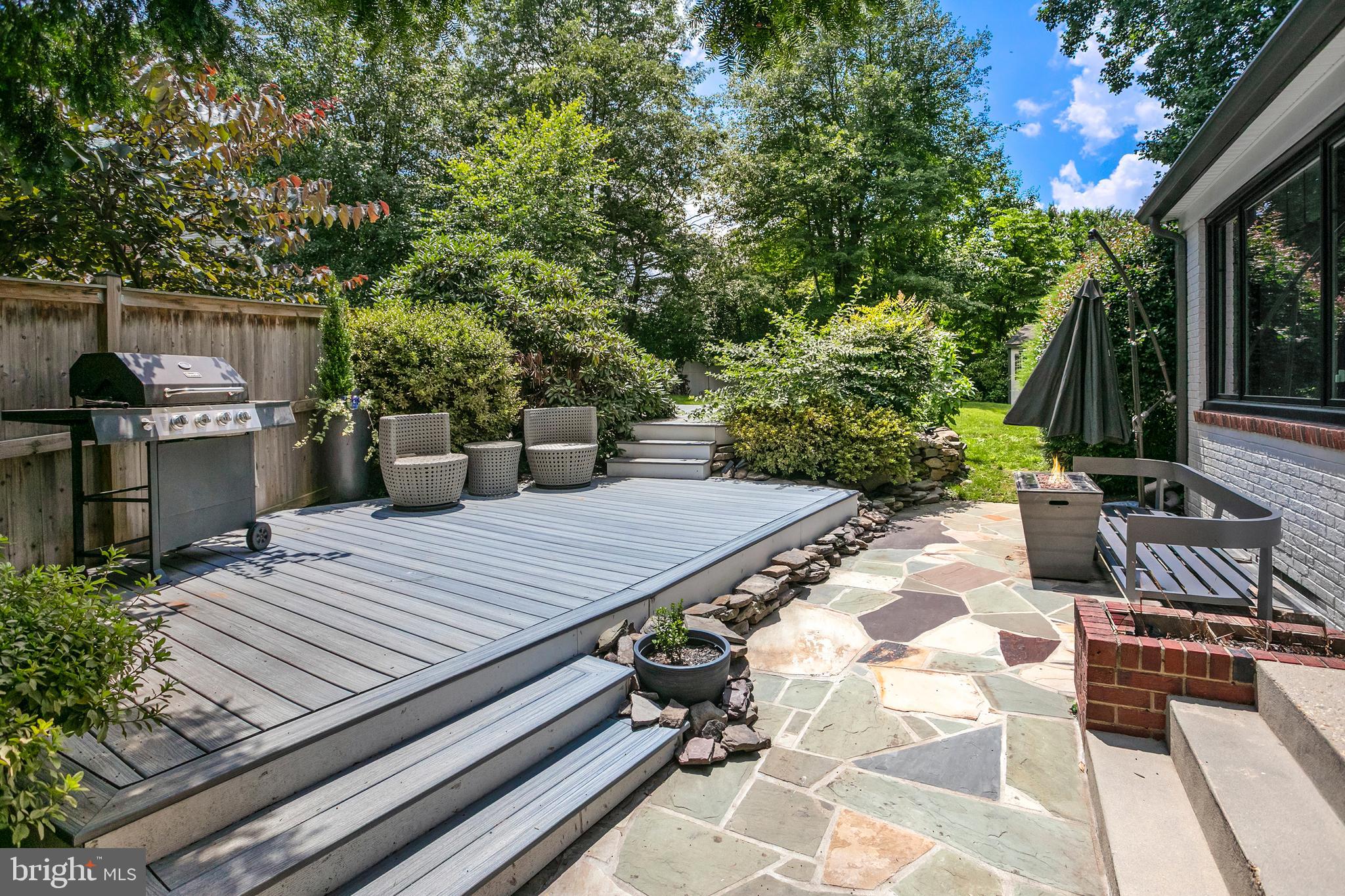 5 Spring Hill Court Chevy Chase, MD 20815 - Photo 38 of 50 a view of a patio with table and chairs potted plants and large tree