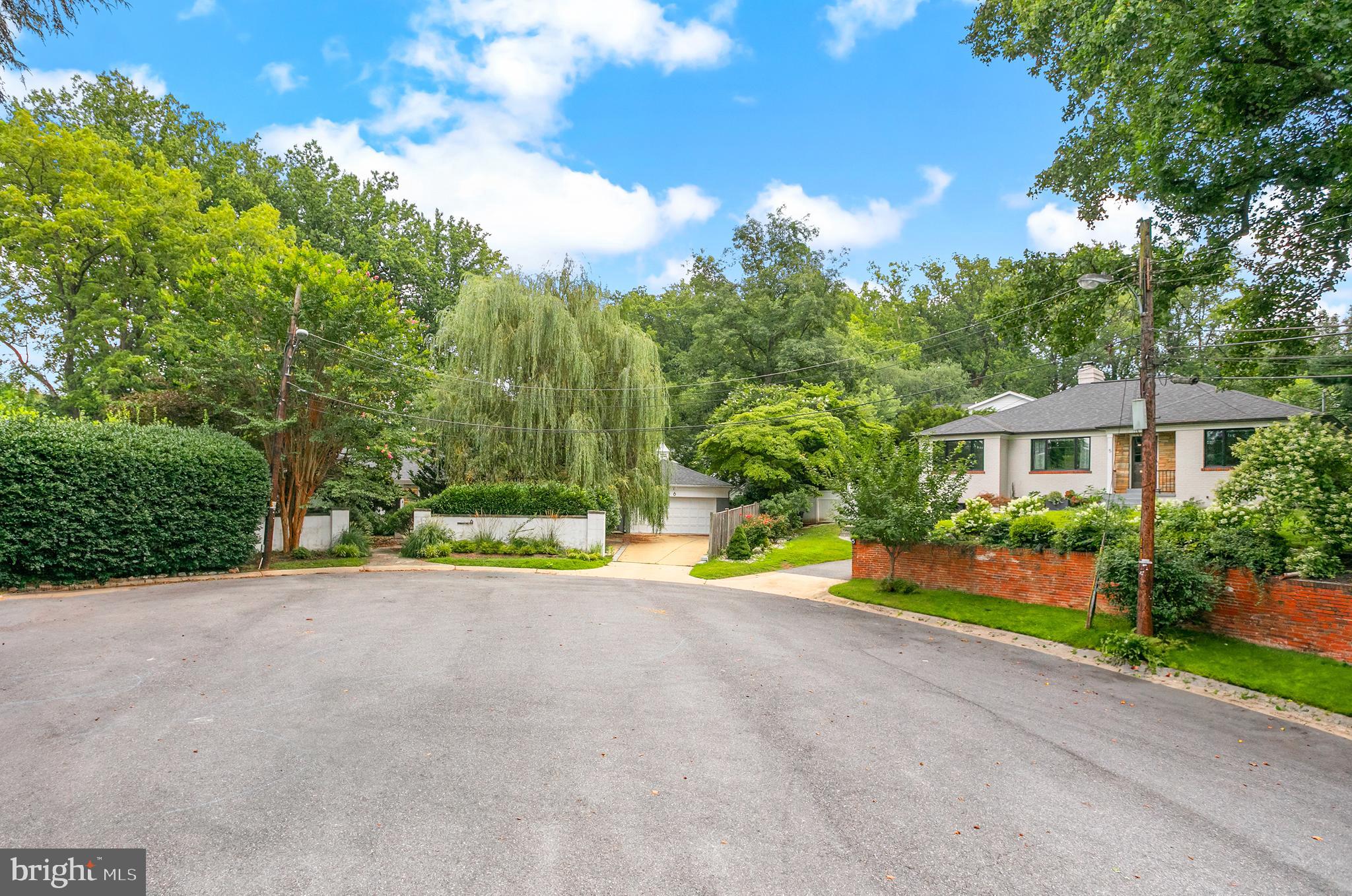 5 Spring Hill Court Chevy Chase, MD 20815 - Photo 4 of 50 a view of a house with a yard and potted plants