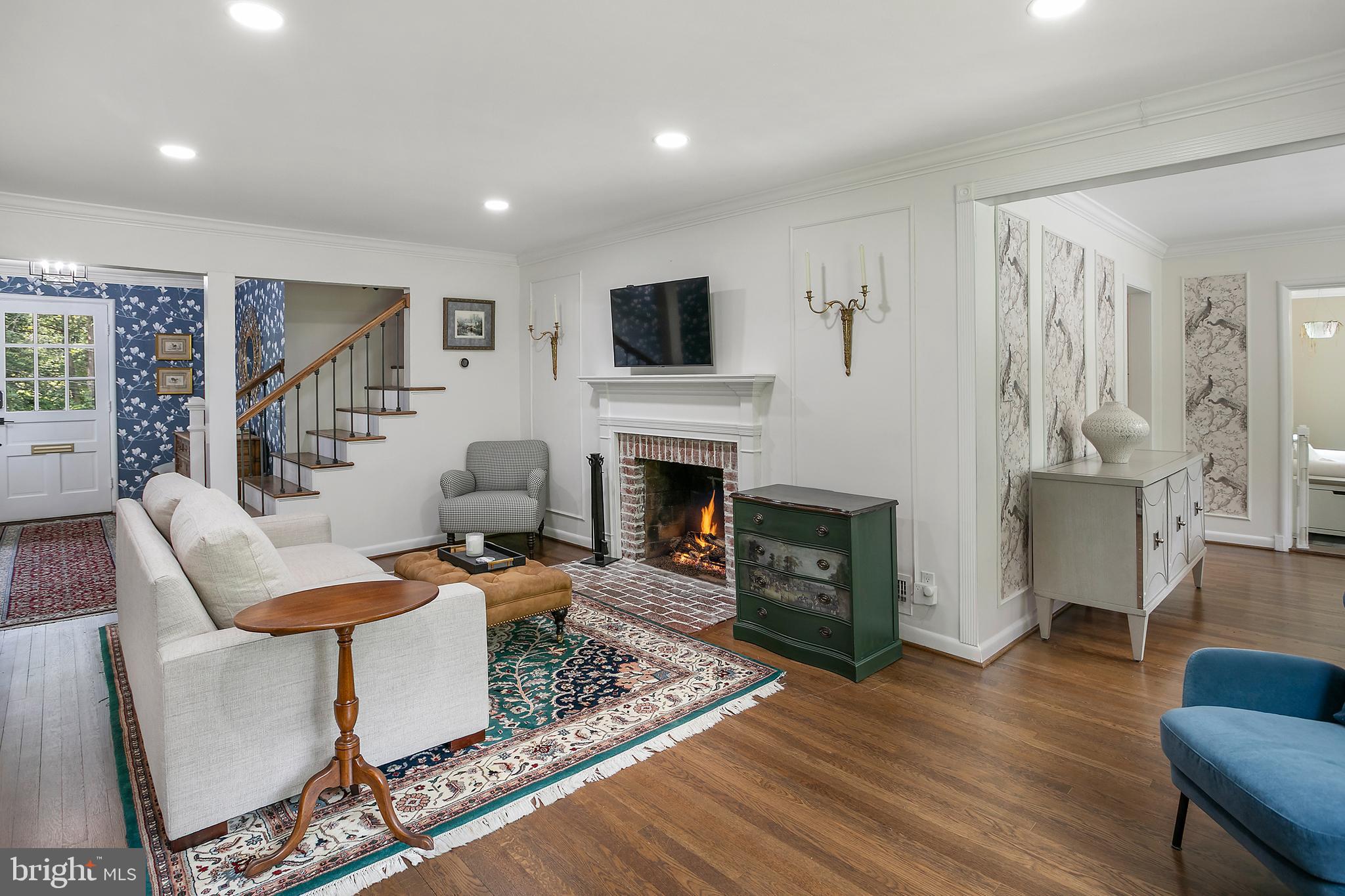 5 Spring Hill Court Chevy Chase, MD 20815 - Photo 8 of 50 a living room with furniture a flat screen tv and a fireplace