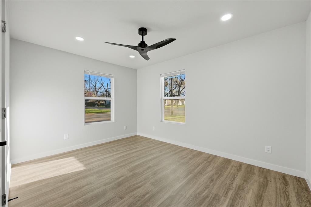 502 Madison Street Cleburne, TX 76033 - Photo 19 of 30 a view of empty room with wooden floor and fan
