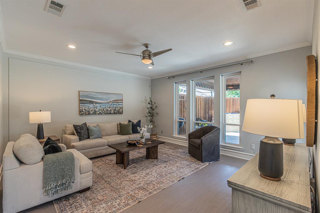300 Sundance Circle Irving, TX 75063 - Photo 25 of 39 Spacious living area featuring light-toned walls, crown molding, and wood-finish flooring