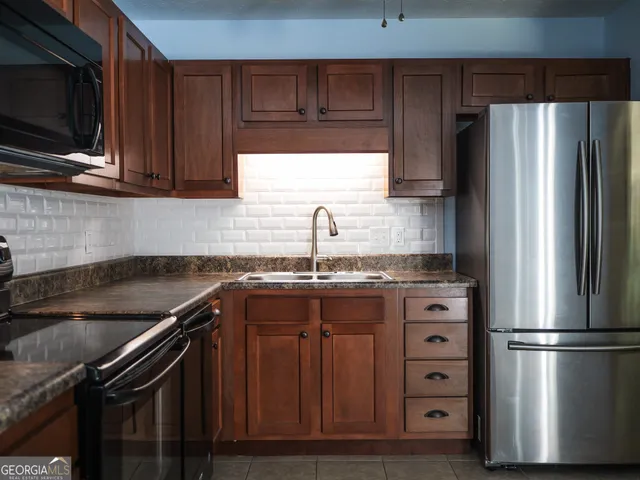 a kitchen with a refrigerator stove and sink