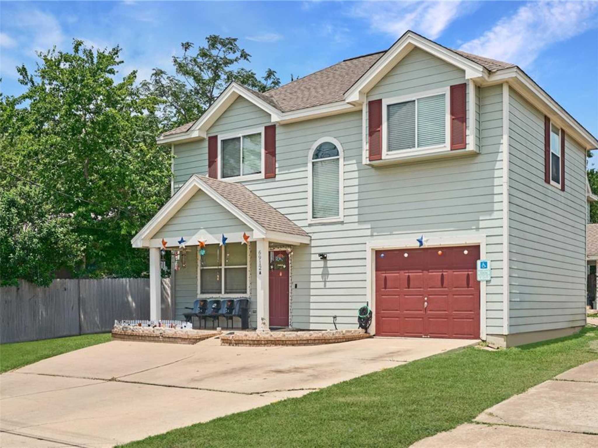 6916 Meador Avenue Austin, TX 78752 - Photo 15 of 29 a front view of a house with a garden