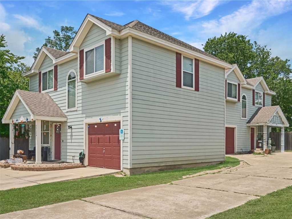 6916 Meador Avenue Austin, TX 78752 - Photo 20 of 29 a front view of a house with a yard and garage