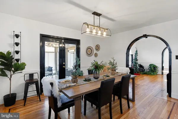 a view of a dining room with furniture wooden floor and chandelier