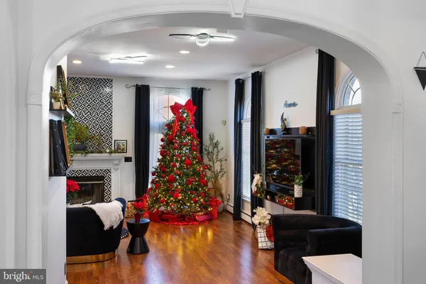 a living room with furniture flowers and a chandelier