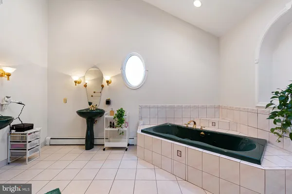 a bedroom with a bed and large windows