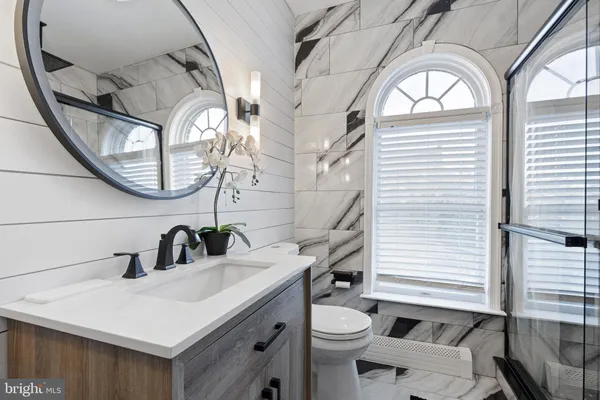 a bedroom with a bed and a flat tv screen