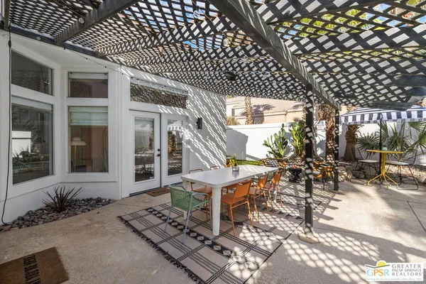 an outdoor view of a house with sitting area