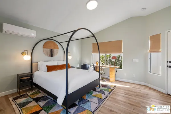 a bed room with a bed and a large mirror