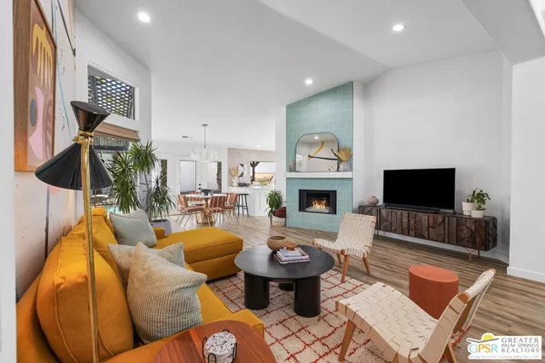 a living room with furniture and a potted plant