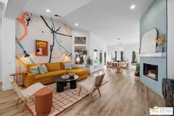 a living room with furniture a rug and a window