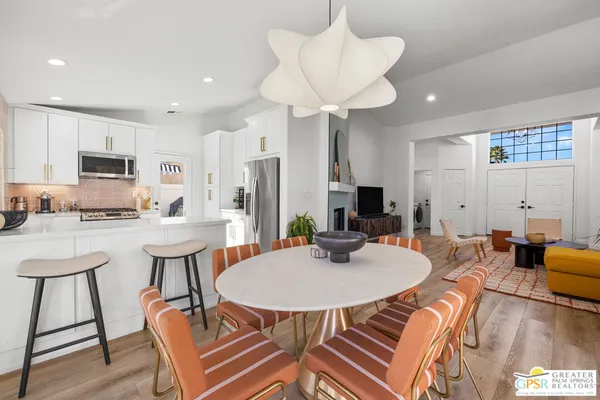 a kitchen with white cabinets and black appliances