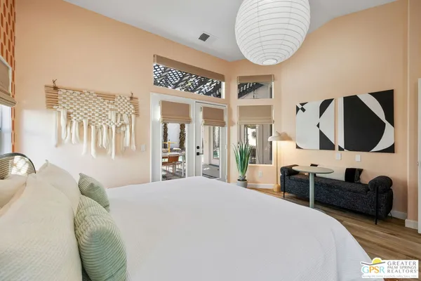 a bedroom with a bed and a mirror