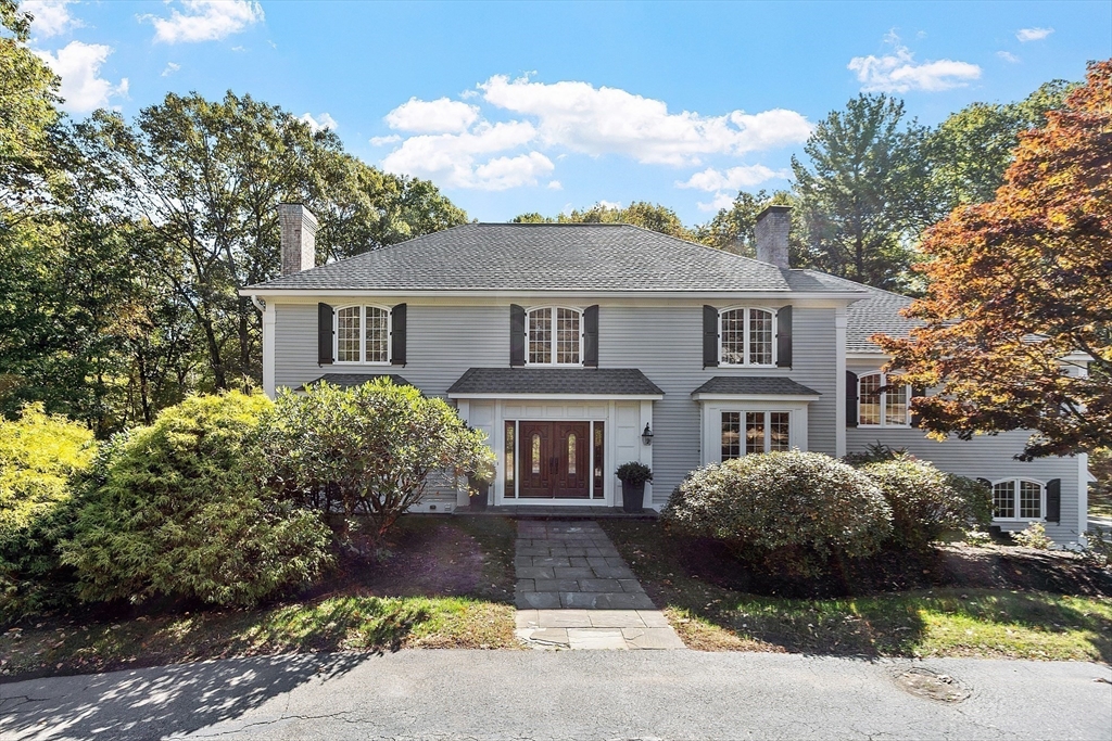 a front view of a house with a garden